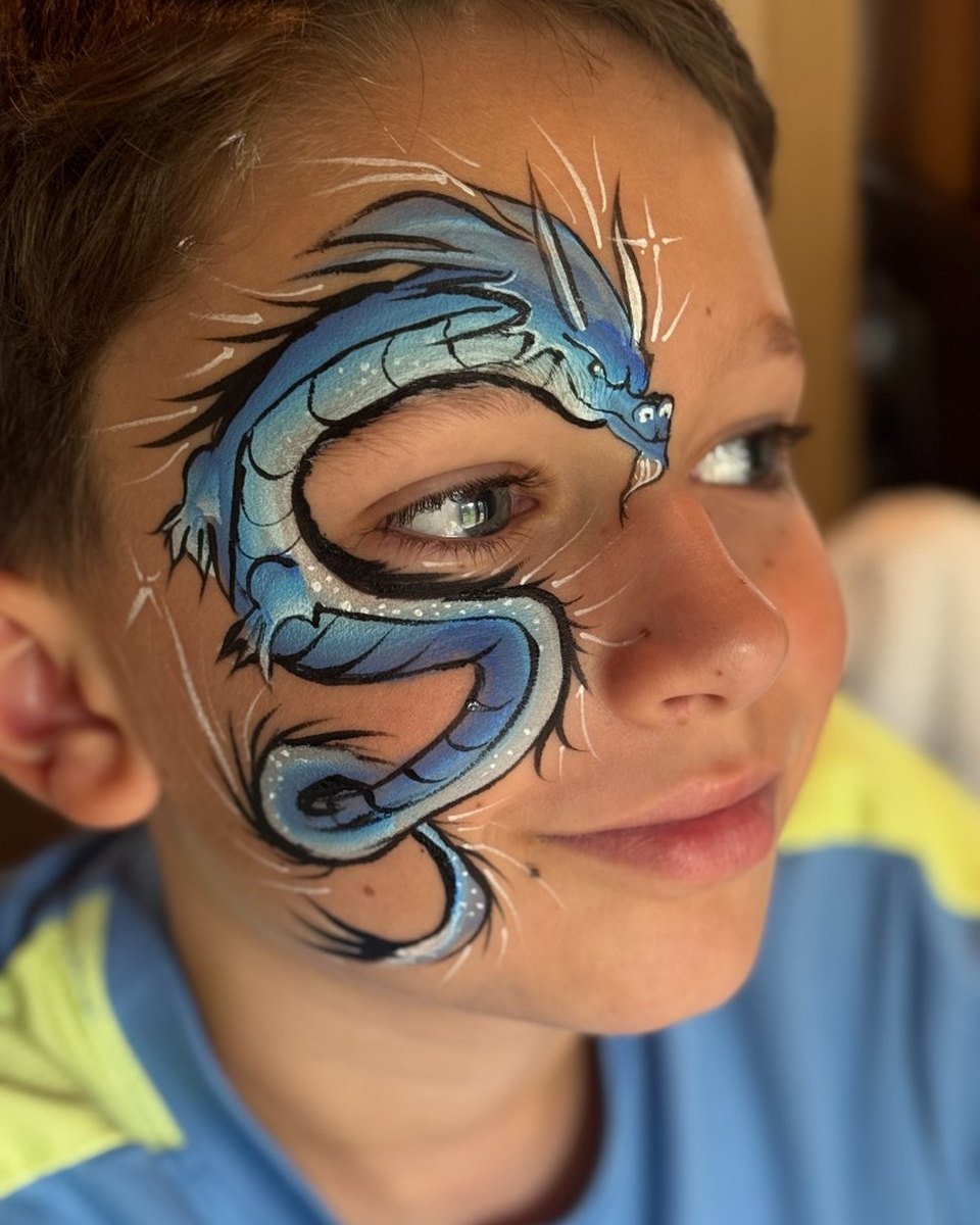 Child with blue dragon face painting by Wildflower Face Art