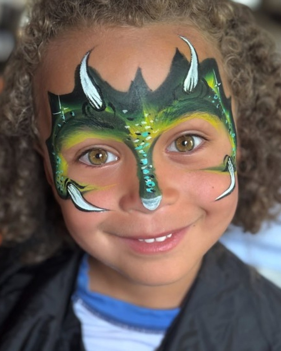 Child with dragon face painting by Wildflower Face Art