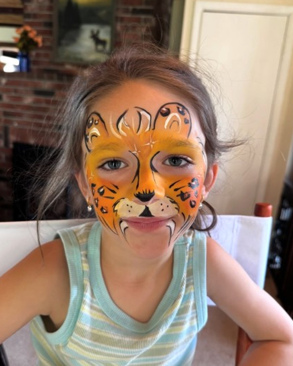 Child with leopard face painting by Wildflower Face Art